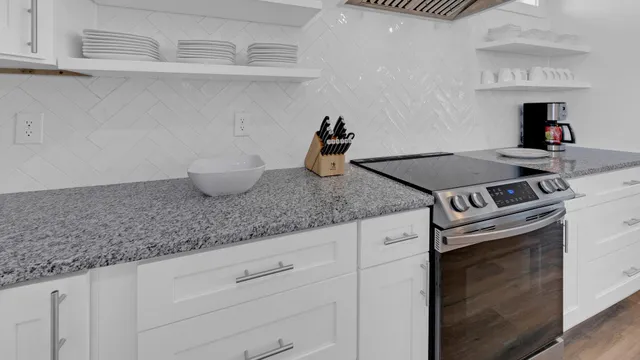 a bathroom with a granite countertop sink vanity mirror and shower