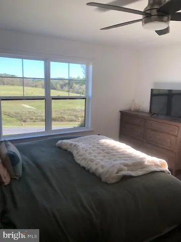 a bed sitting in a bedroom next to a window