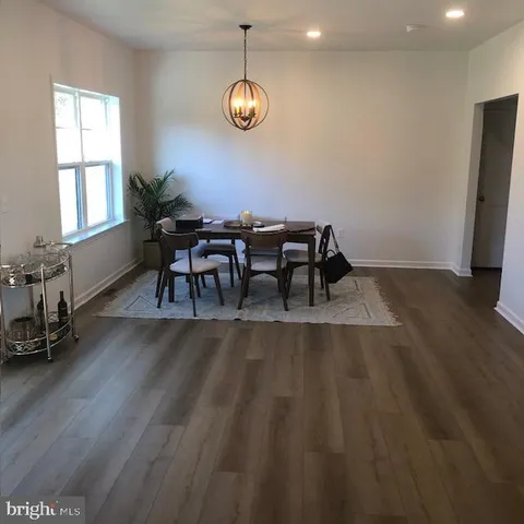 a view of a dining room with furniture and a chandelier