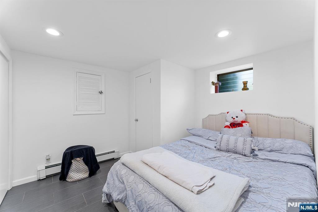 111 East 10th Street Linden, NJ 07036 - Photo 17 of 39 a bedroom with a bed and a chair