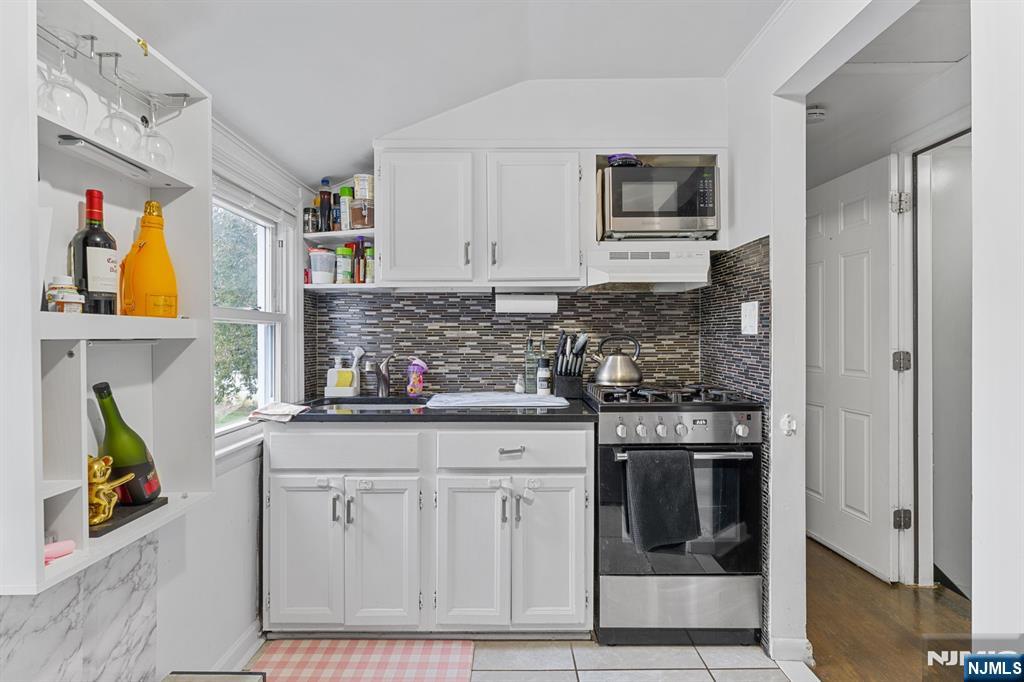 111 East 10th Street Linden, NJ 07036 - Photo 22 of 39 a kitchen with stainless steel appliances granite countertop a refrigerator and a stove