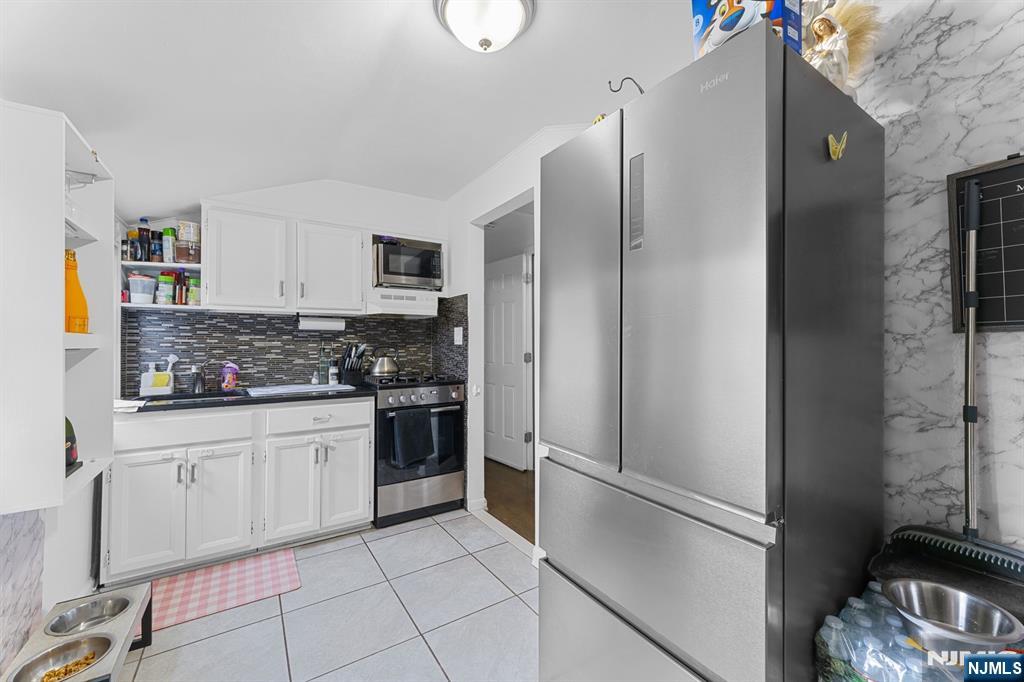 111 East 10th Street Linden, NJ 07036 - Photo 23 of 39 a kitchen with stainless steel appliances granite countertop a refrigerator and a sink