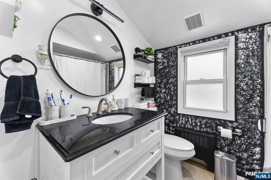 111 East 10th Street Linden, NJ 07036 - Photo 27 of 39 a bathroom with a sink a toilet and a mirror
