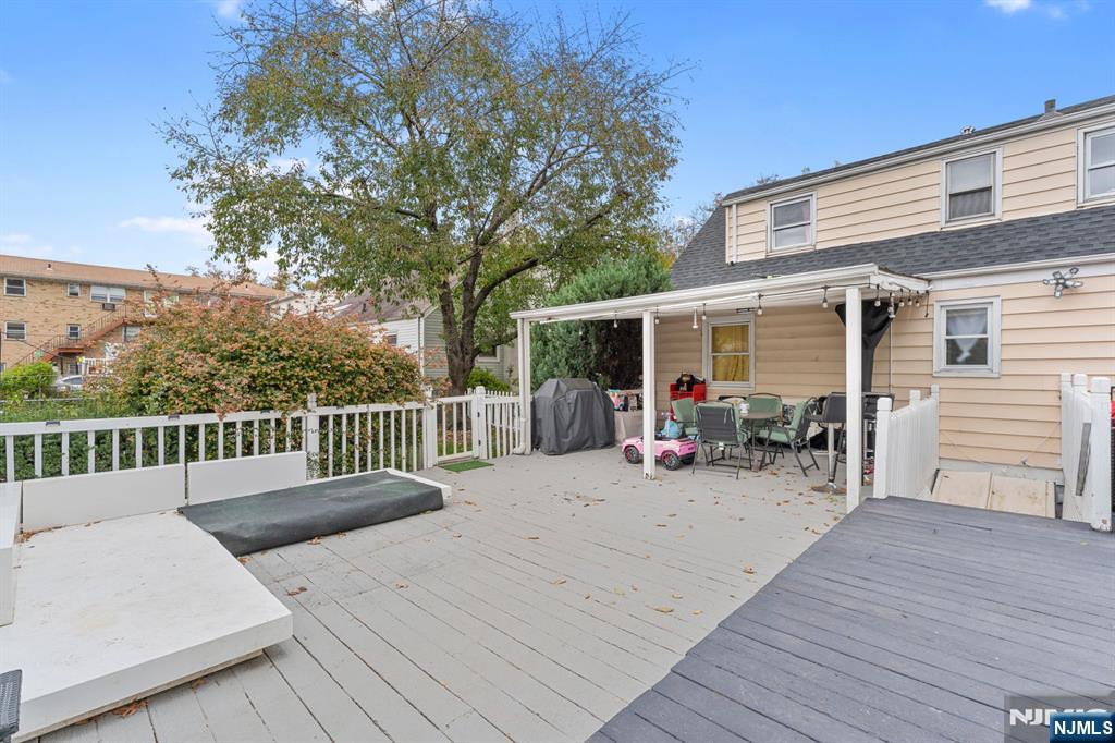 111 East 10th Street Linden, NJ 07036 - Photo 29 of 39 a view of a deck with table and chairs and wooden floor