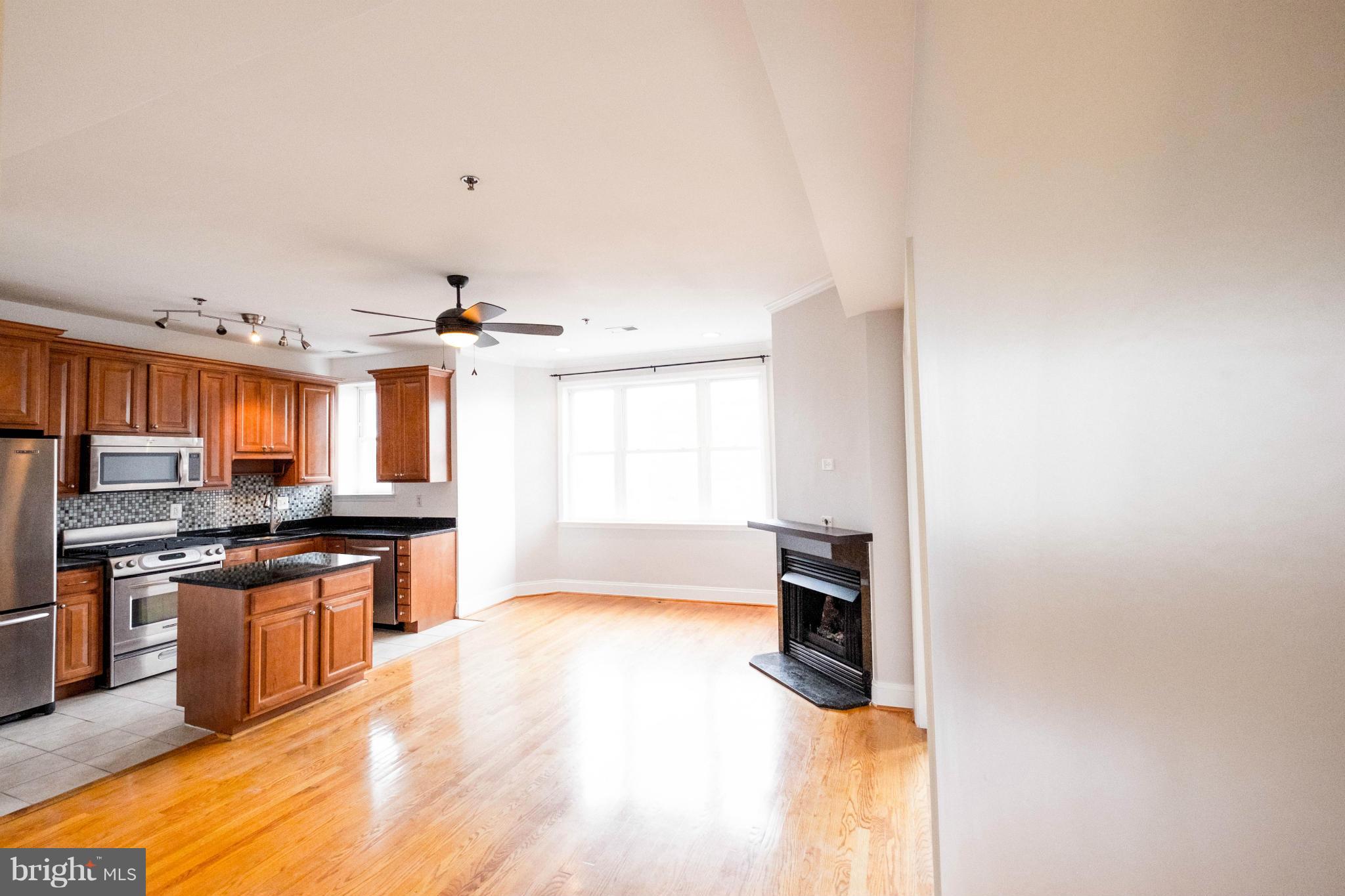 1438 Columbia Road Northwest, Unit 401 Washington, DC 20009 - Photo 1 of 10 a kitchen with granite countertop a stove top oven and sink