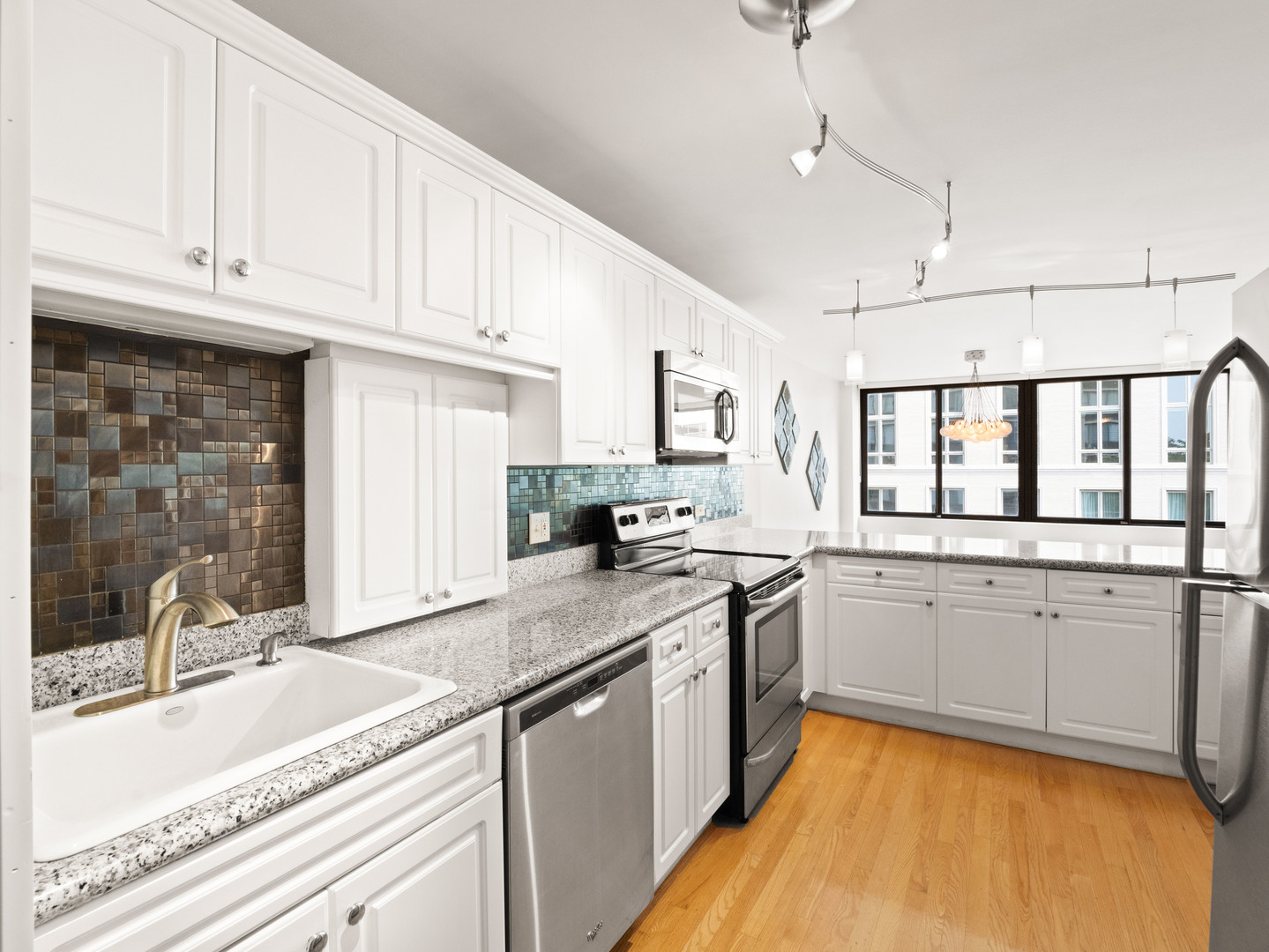 2754 North Hampden Court, Unit 708 Chicago, IL 60614 - Photo 7 of 27 a kitchen with a sink stove and cabinets