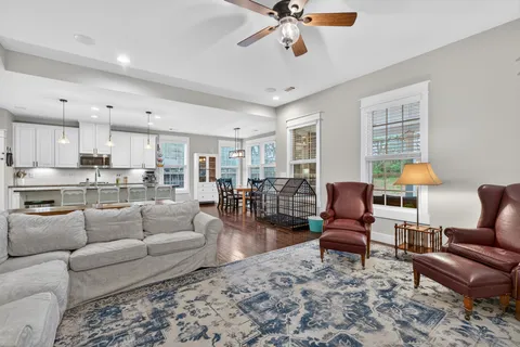 a living room with furniture and wooden floor