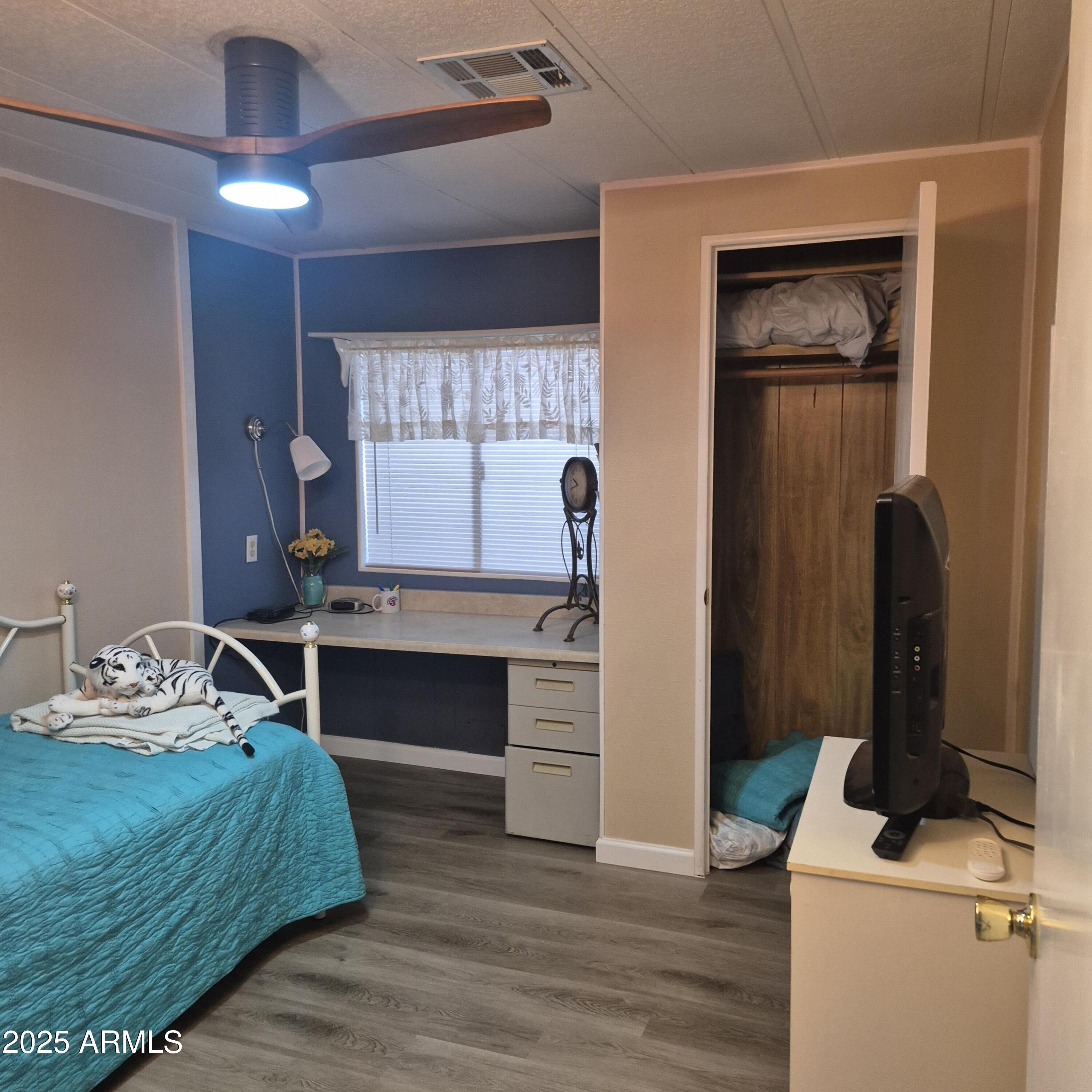 661 South Hawes Road, Unit 25 Mesa, AZ 85208 - Photo 13 of 50 a bedroom with a bed and a chandelier