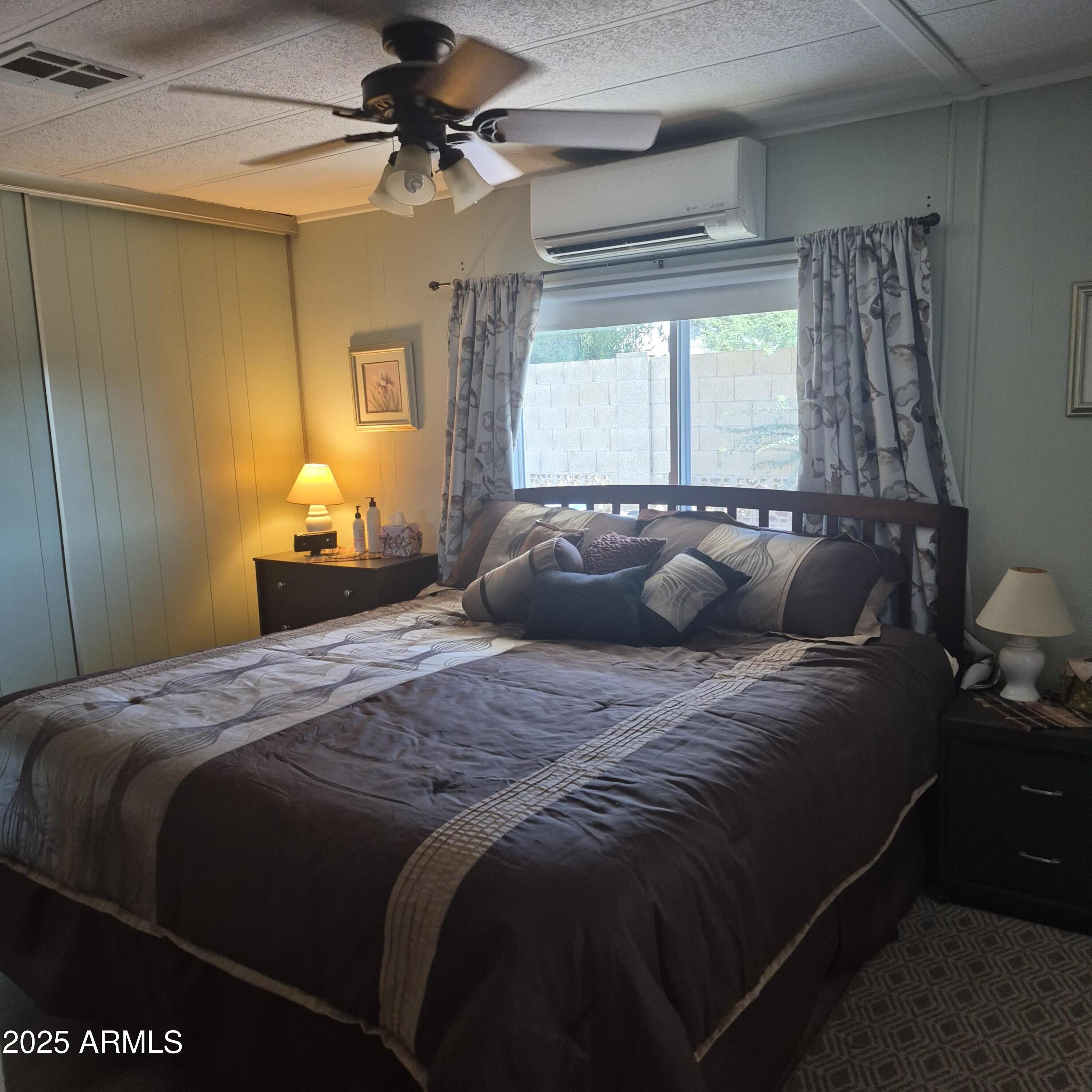 661 South Hawes Road, Unit 25 Mesa, AZ 85208 - Photo 14 of 50 a large bed sitting in a bedroom next to a window