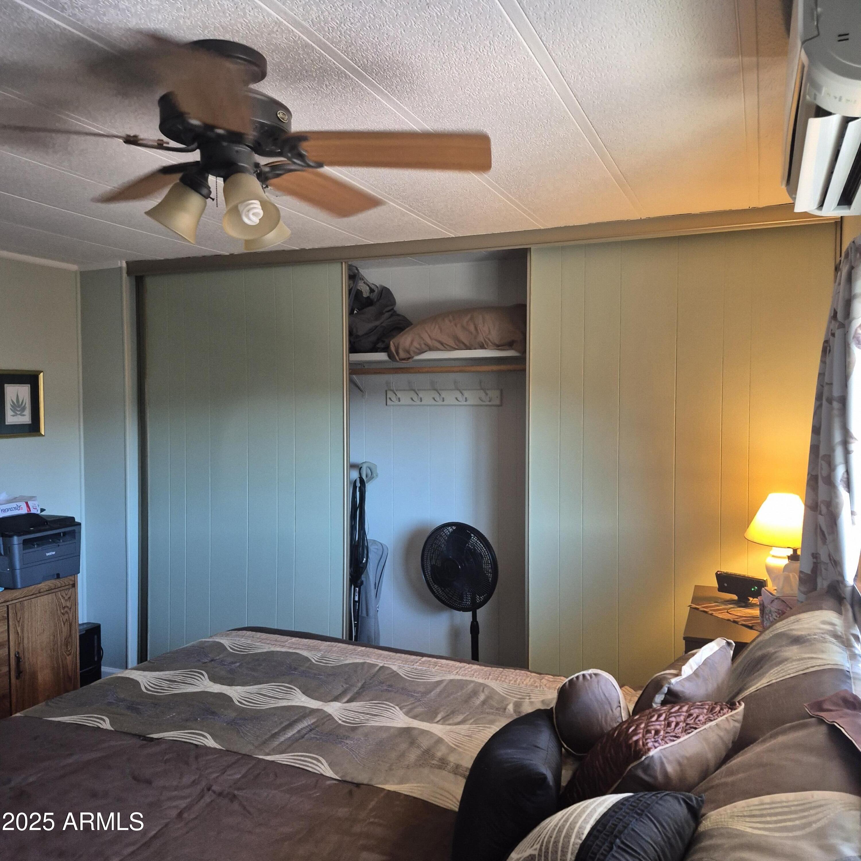 661 South Hawes Road, Unit 25 Mesa, AZ 85208 - Photo 15 of 50 a bedroom with a bed and cabinets