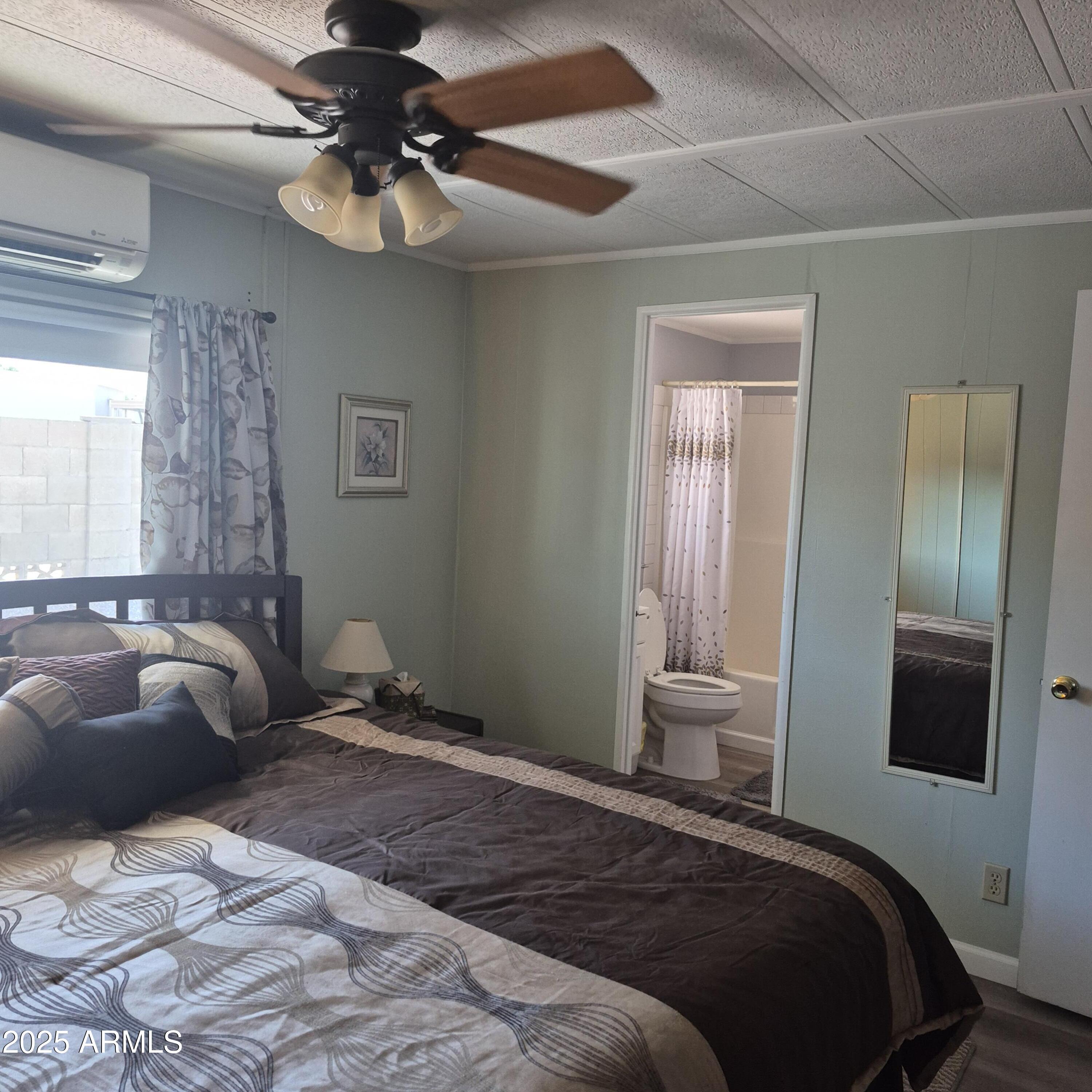 661 South Hawes Road, Unit 25 Mesa, AZ 85208 - Photo 16 of 50 a bedroom with a bed and a chandelier