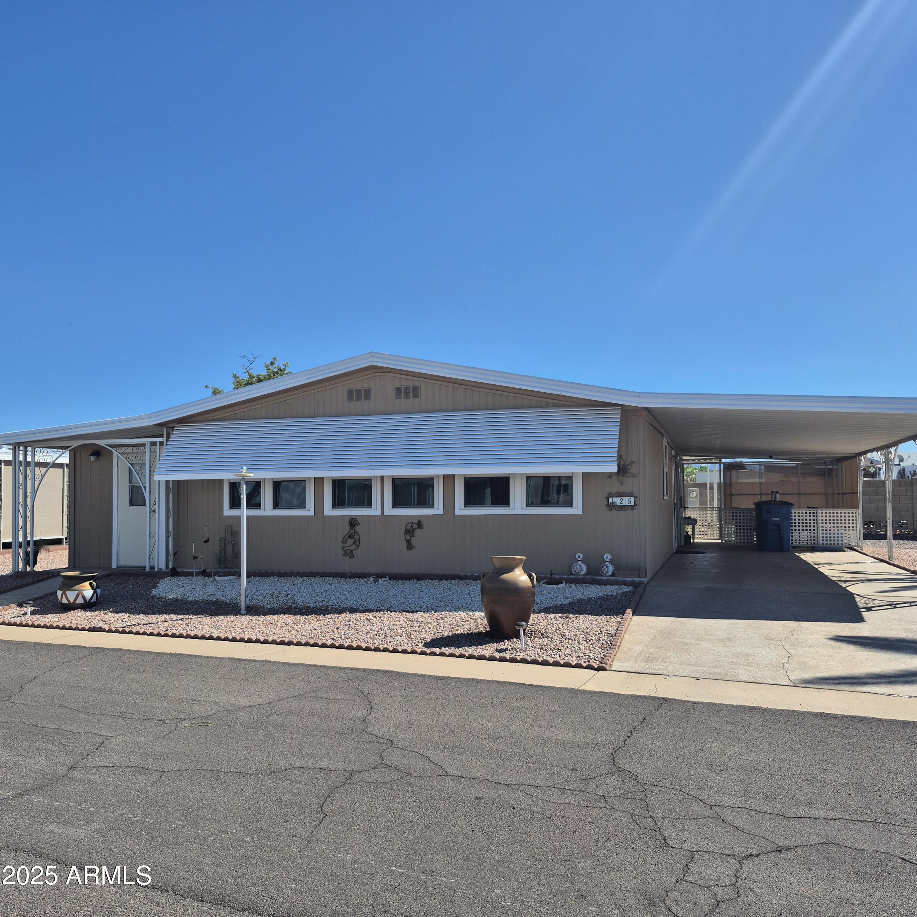 661 South Hawes Road, Unit 25 Mesa, AZ 85208 - Photo 2 of 50 a front view of a house with a yard
