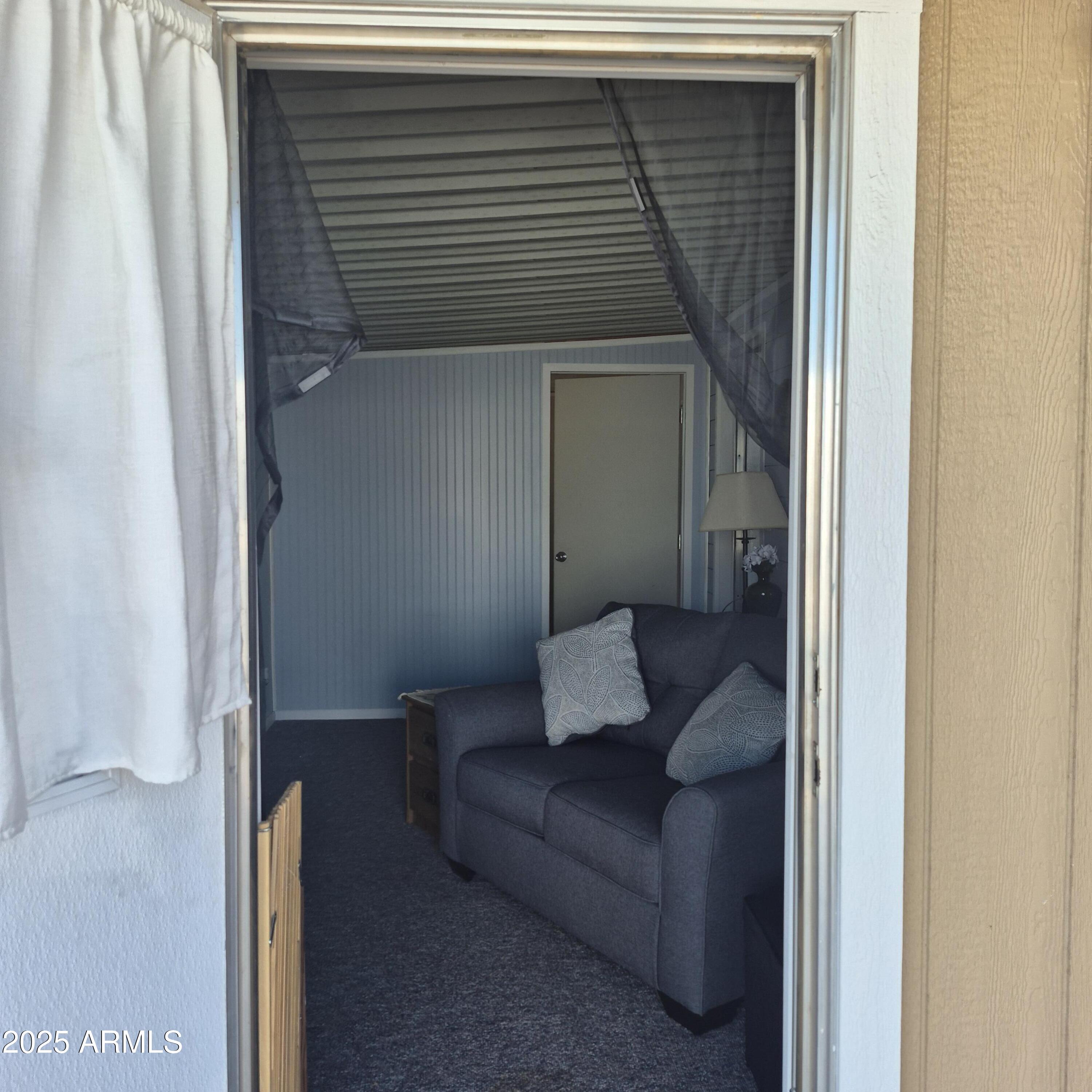 661 South Hawes Road, Unit 25 Mesa, AZ 85208 - Photo 32 of 50 a living room with furniture and a gate