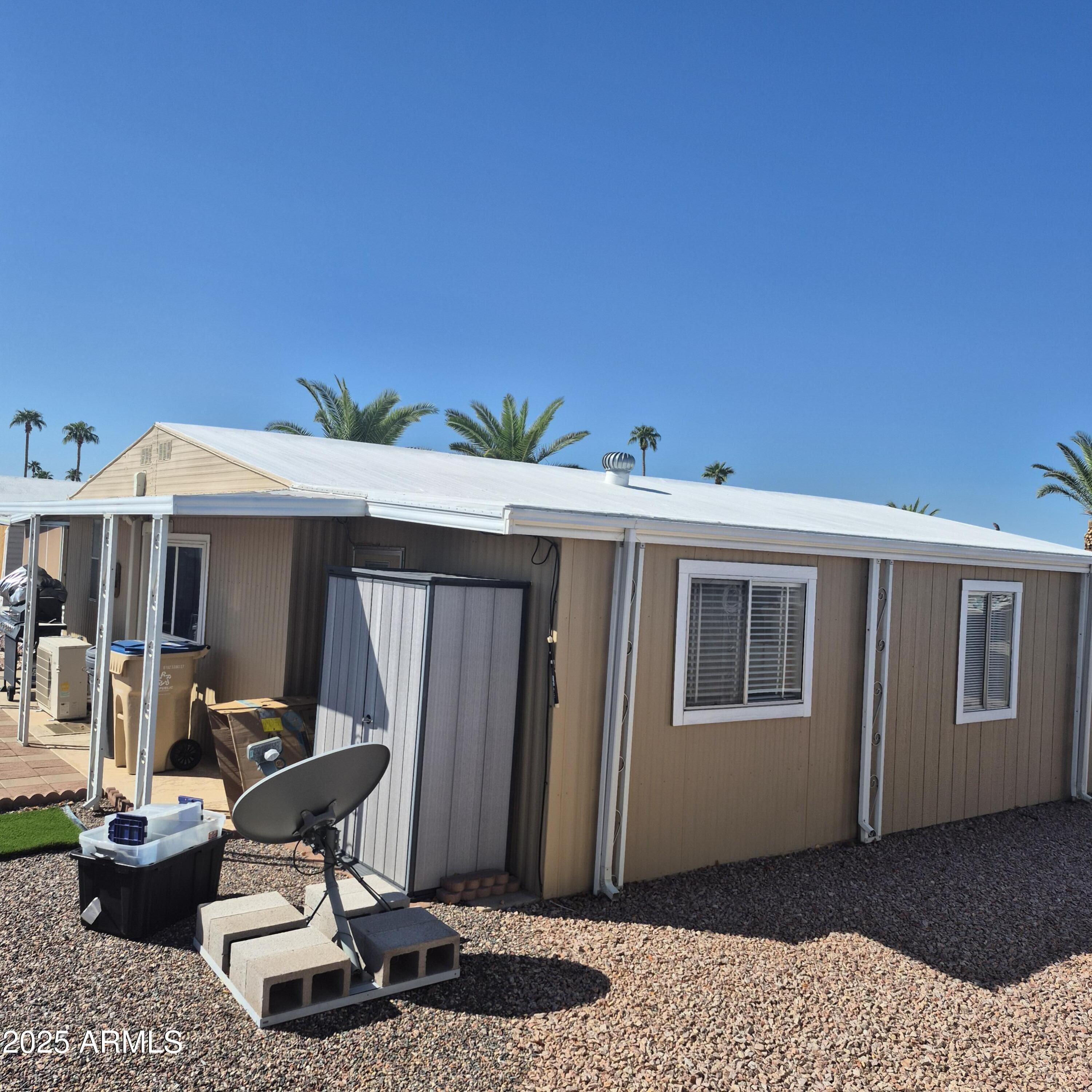 661 South Hawes Road, Unit 25 Mesa, AZ 85208 - Photo 48 of 50 a table and chairs in front of a house