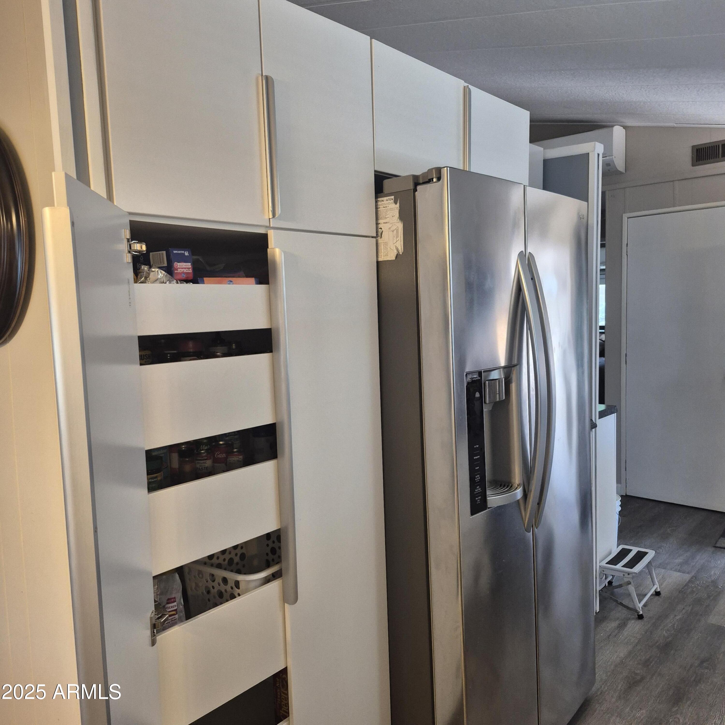 661 South Hawes Road, Unit 25 Mesa, AZ 85208 - Photo 7 of 50 a metallic refrigerator freezer sitting in a kitchen