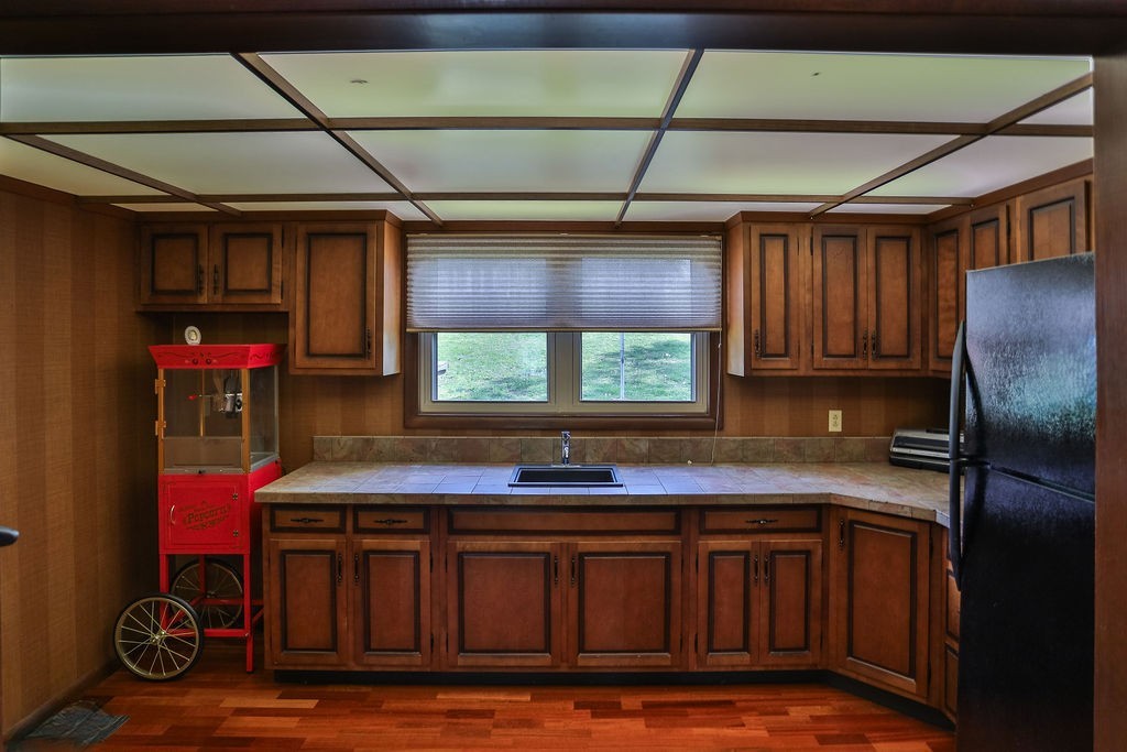 305 Myers Terrace Carthage, TN 37030 - Photo 32 of 75 a kitchen with stainless steel appliances granite countertop a sink window and cabinets