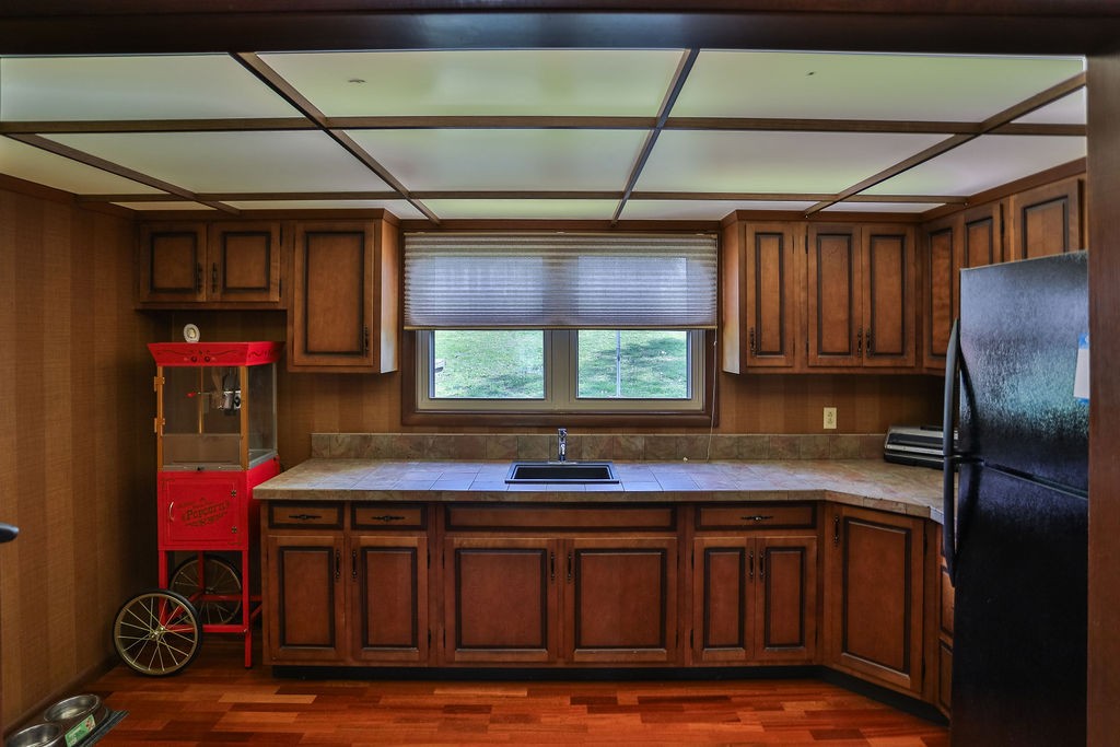 305 Myers Terrace Carthage, TN 37030 - Photo 34 of 75 a kitchen with stainless steel appliances granite countertop a sink window and cabinets