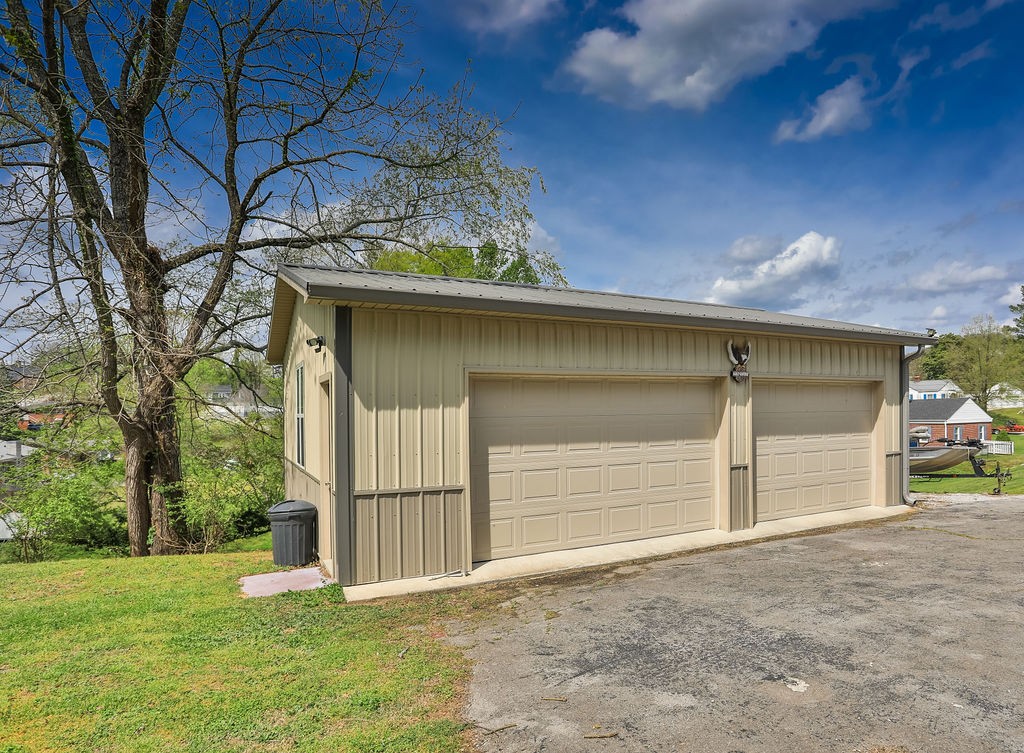 305 Myers Terrace Carthage, TN 37030 - Photo 44 of 75 a front view of a house with a yard and garage
