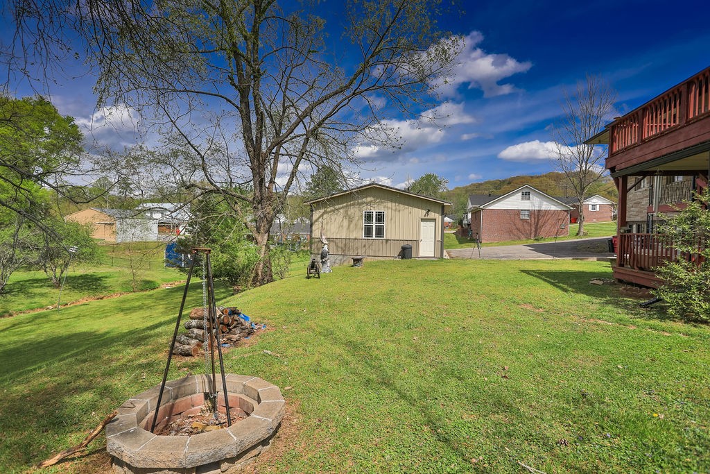 305 Myers Terrace Carthage, TN 37030 - Photo 68 of 75 a backyard of a house with a fountain table and chairs
