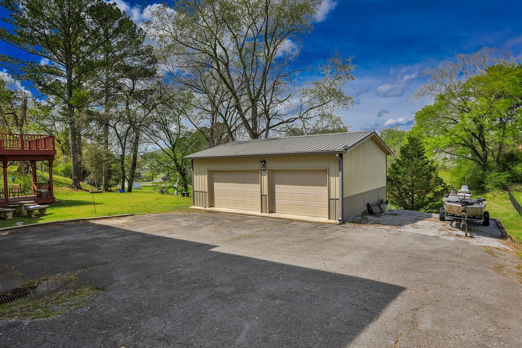305 Myers Terrace Carthage, TN 37030 - Photo 72 of 75 a view of a house with a yard and garage