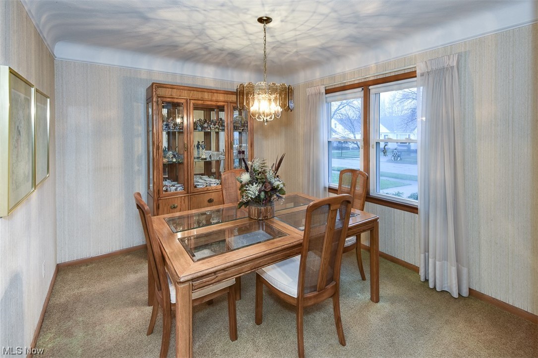 4026 Stonehaven Road Cleveland, OH 44121 - Photo 5 of 30 Carpeted dining area with a notable chandelier