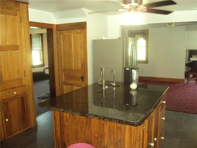 a kitchen with a large window appliances and cabinets
