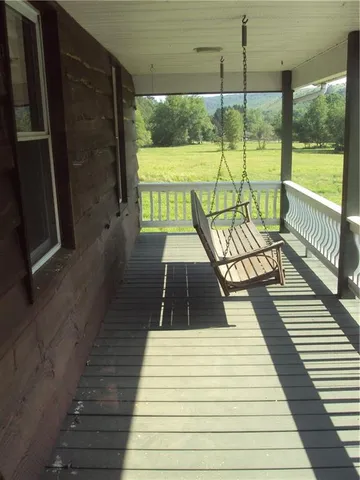 a bathroom with a granite countertop toilet sink and mirror