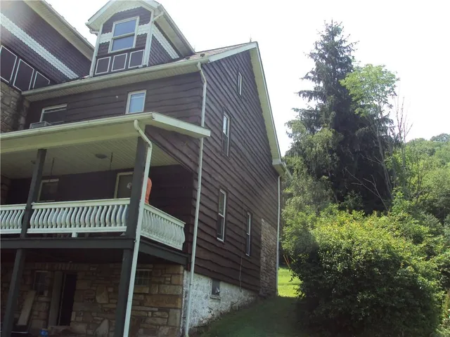 a view of a house with a tree front of a house