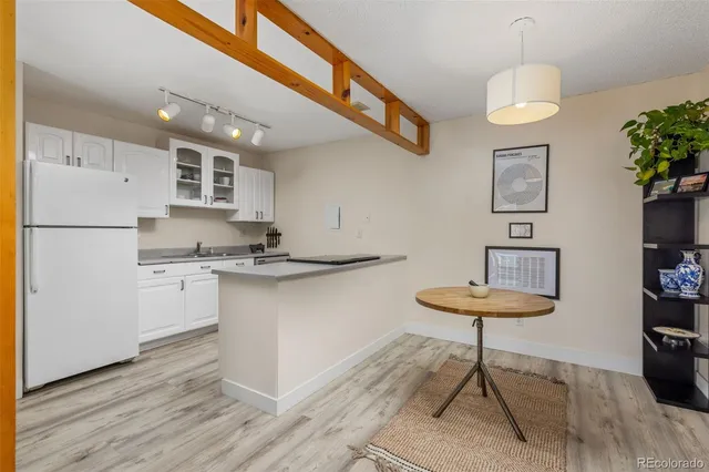 a kitchen with stainless steel appliances granite countertop a refrigerator a stove and a sink with granite countertops