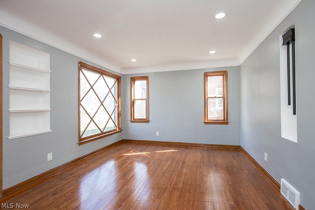 2231 Lorimer Road Cleveland, OH 44134 - Photo 5 of 28 Unfurnished room featuring hardwood / wood-style flooring and built in shelves