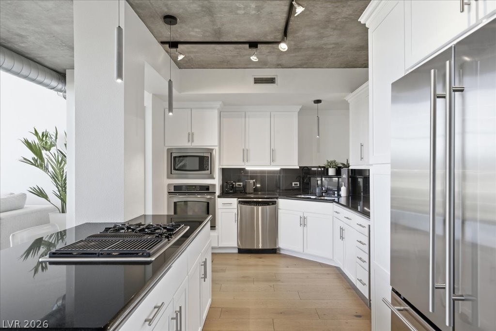 360 East Desert Inn Road, Unit 604 Las Vegas, NV 89109 - Photo 19 of 28 Culinary creativity awaits in this modern kitchen featuring a gas cooktop and sleek stainless steel appliances.