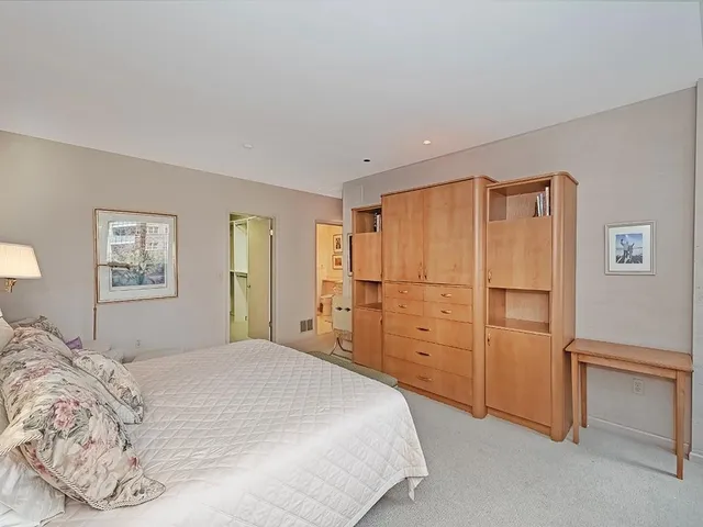 a bathroom with a granite countertop sink a toilet and a mirror