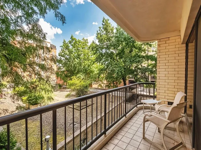 a view of a patio with table and chairs and potted plants