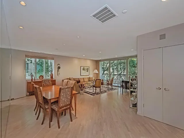 a dining room with furniture wooden floor and a rug