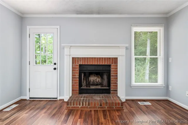 a living room with a fireplace and a floor to ceiling window