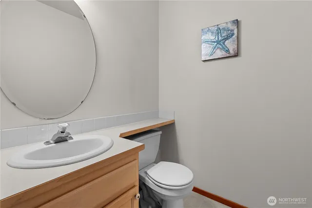 a bathroom with a sink mirror and toilet