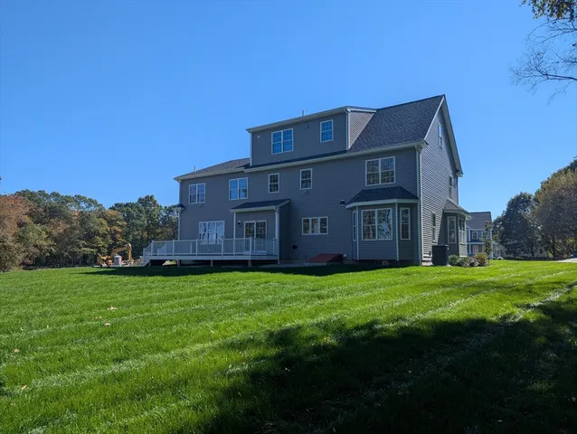 a view of a big house with a big yard and large trees