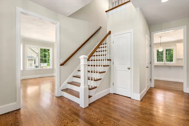wooden view of an entryway with wooden floor and staircase