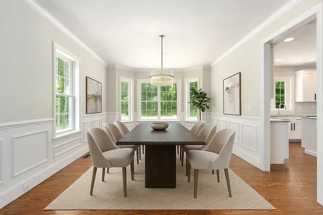a view of a dining room with furniture window and wooden floor