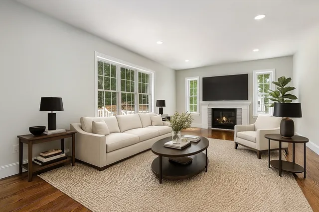a living room with furniture a fireplace and a flat screen tv