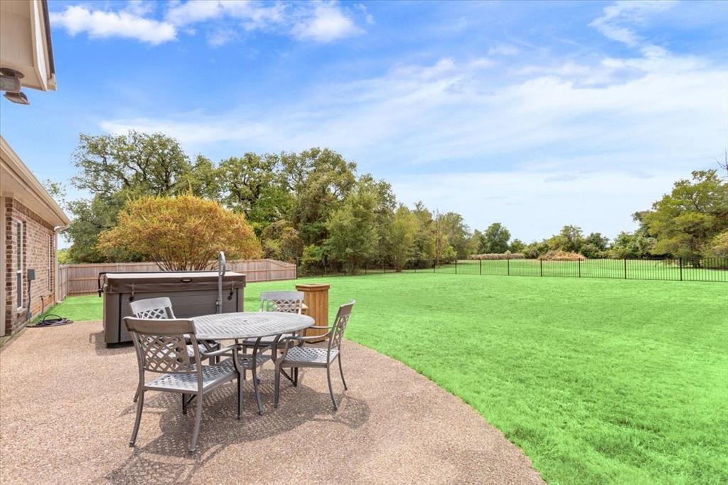 111 Spring Creek Street Waco, TX 76705 - Photo 38 of 40 Expansive backyard featuring a manicured lawn, established perimeter fencing, and a concrete patio