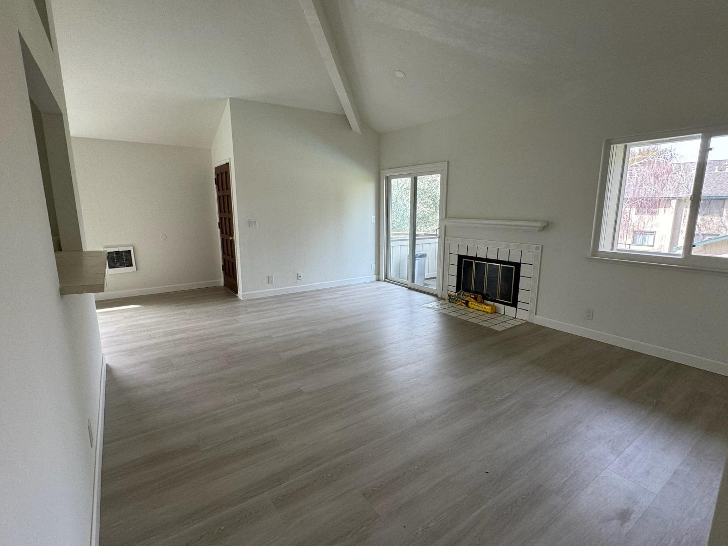 1460 Alma Loop San Jose, CA 95125 - Photo 3 of 14 an empty room with wooden floor fireplace and windows