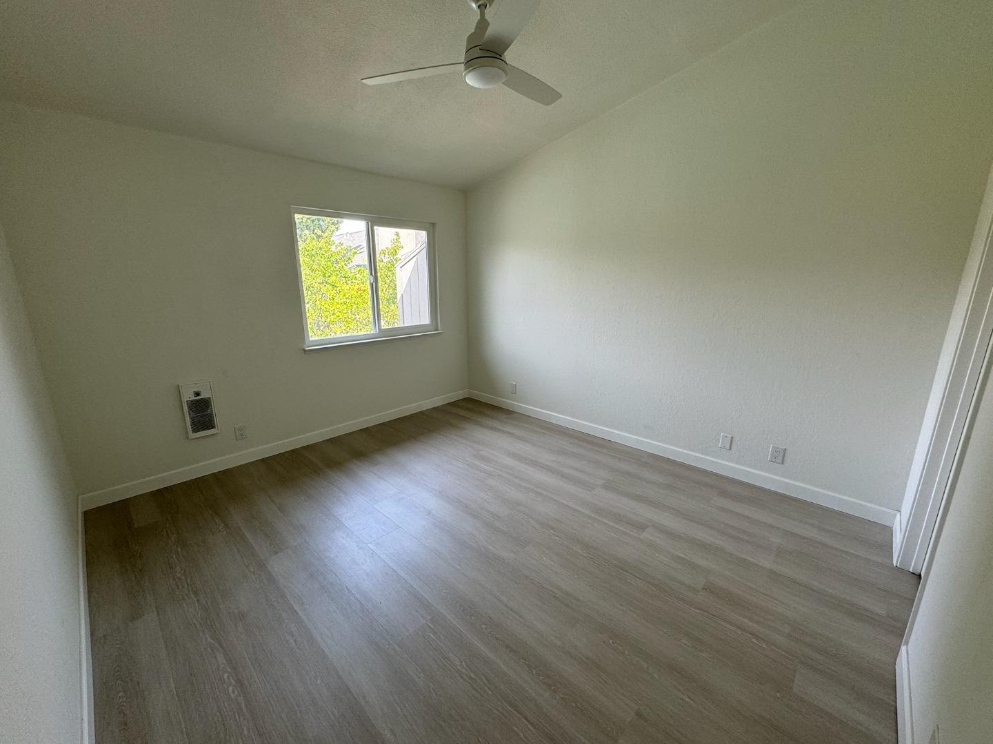 1460 Alma Loop San Jose, CA 95125 - Photo 7 of 14 an empty room with wooden floor and windows