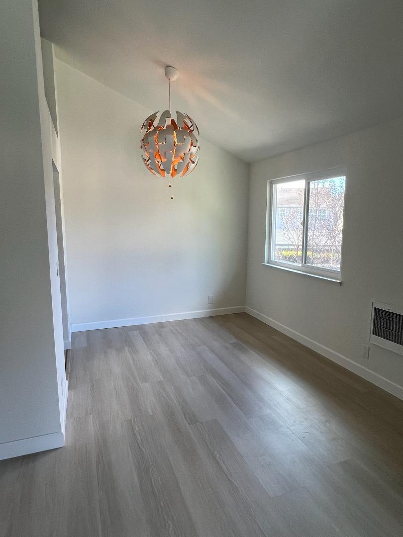 1460 Alma Loop San Jose, CA 95125 - Photo 10 of 14 an empty room with wooden floor and window