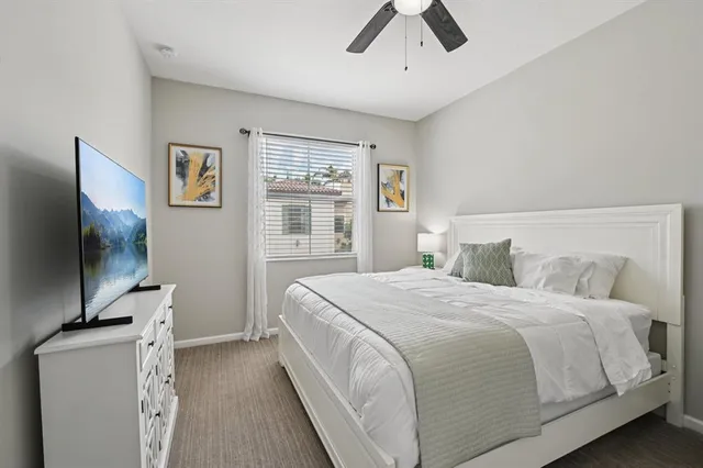 a bedroom with a large bed and a flat screen tv