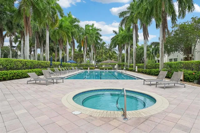 a swimming pool with outdoor seating and yard