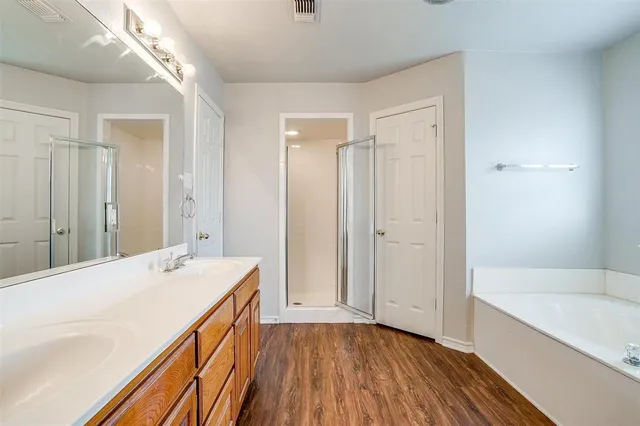 a bathroom with a sink a mirror and a bathtub