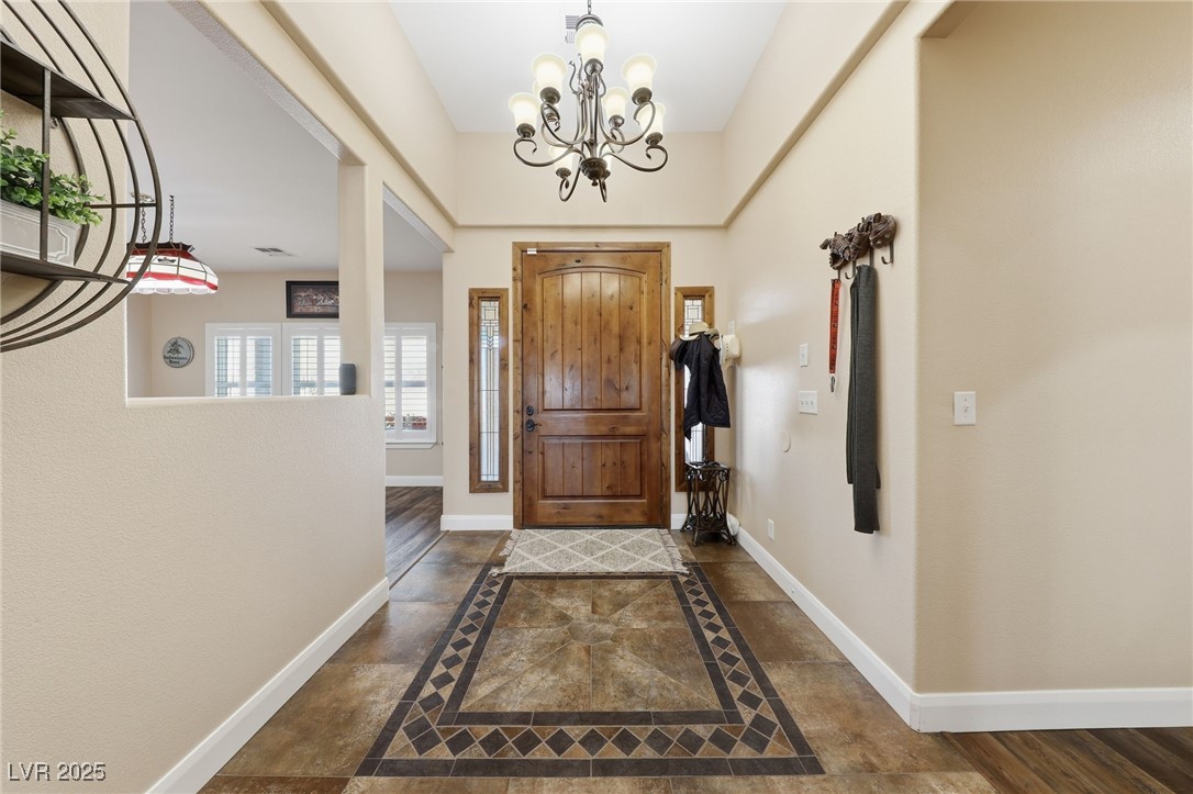 1285 Embry Avenue Moapa, NV 89025 - Photo 22 of 98 Foyer with inlaid floor details and a chandelier