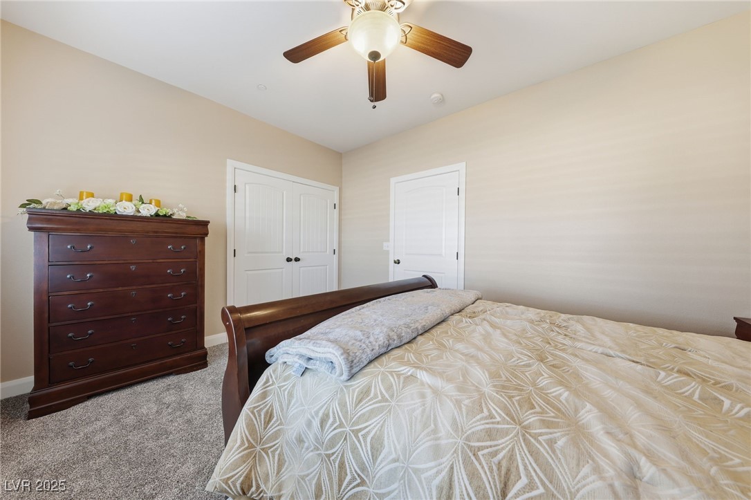 1285 Embry Avenue Moapa, NV 89025 - Photo 25 of 98 Bedroom featuring carpet floors, a closet, and a ceiling fan
