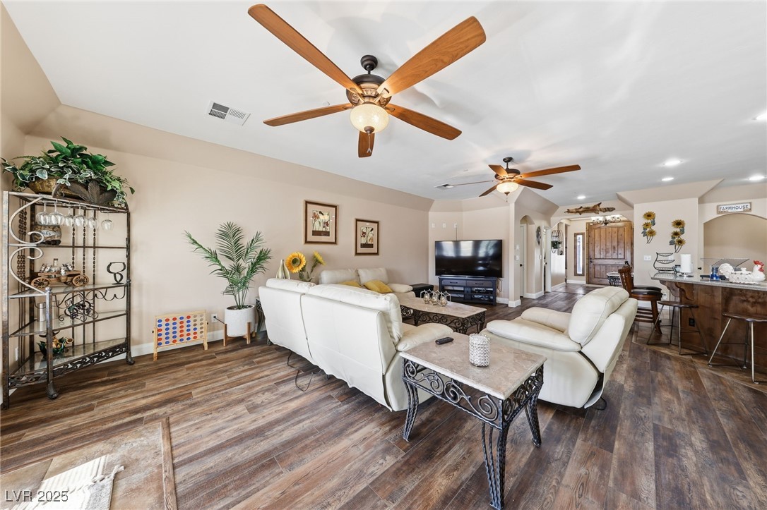 1285 Embry Avenue Moapa, NV 89025 - Photo 32 of 98 Living room featuring dark wood-style flooring, arched walkways, recessed lighting, and a ceiling fan